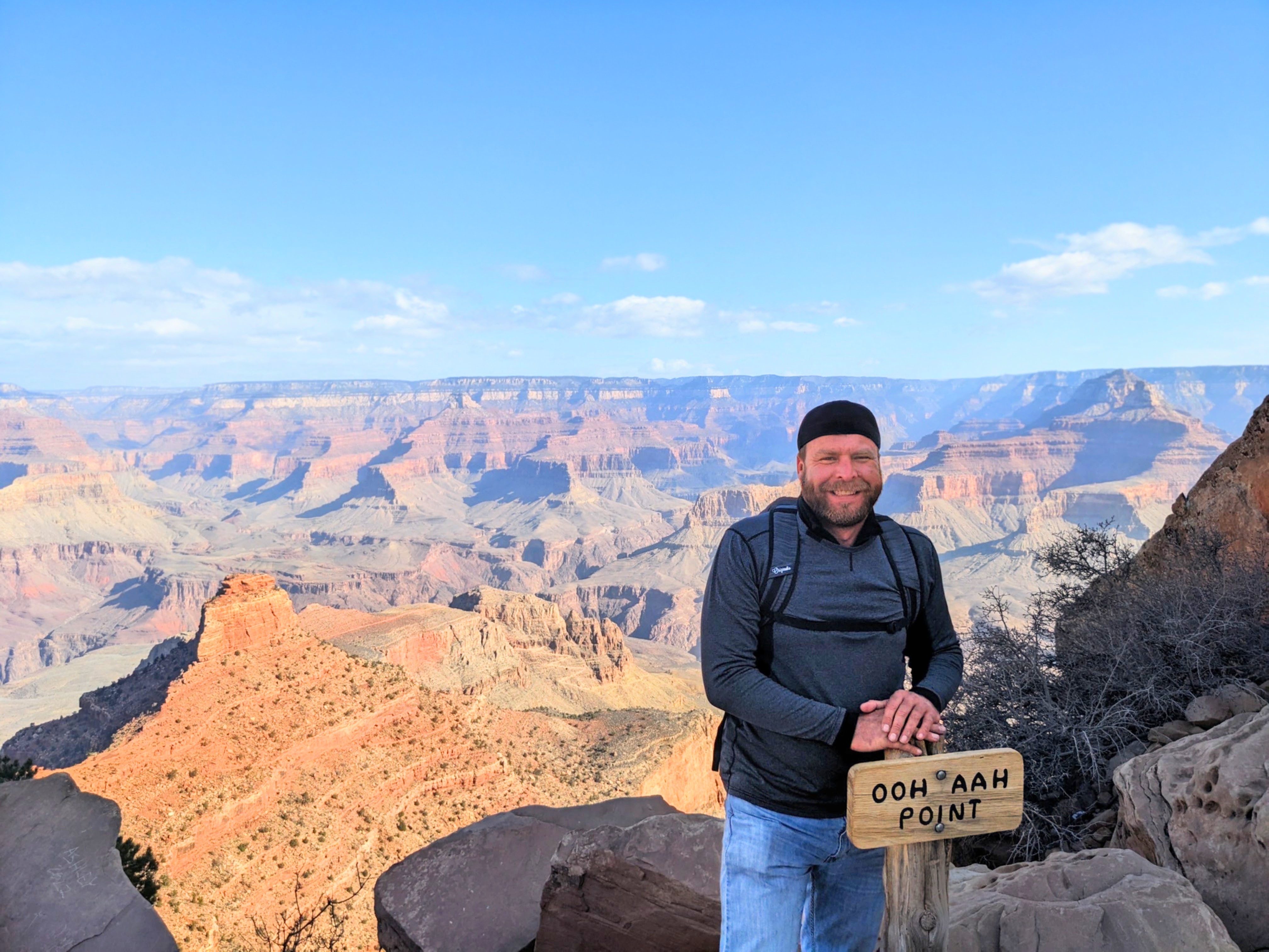A hiker at Ooh Aah Point on the South Kaibab Trail above the Grand Canyon