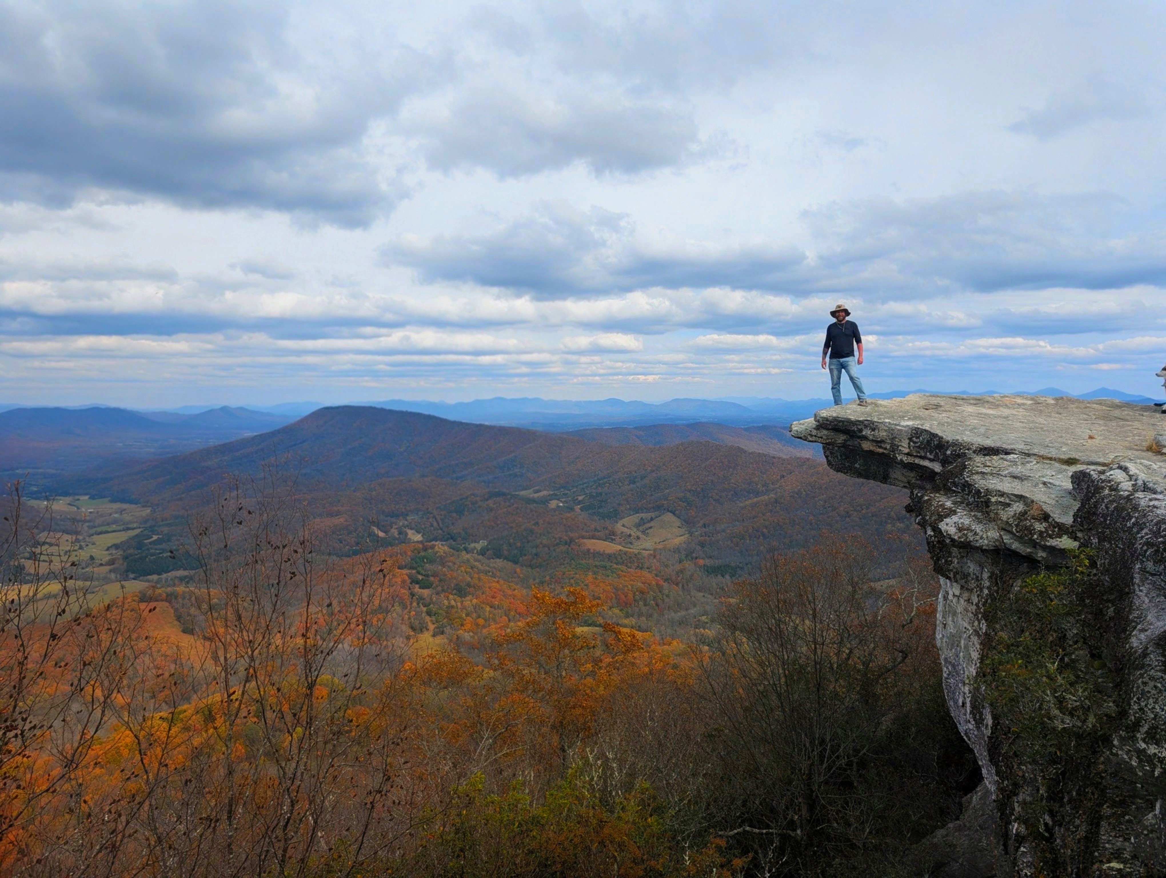 A figure on the cantilevered ledge of McAfee Knob above the Catawba Valley